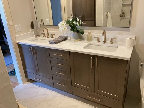 Finished wood-tone double sink bathroom vanity with quartz countertop
